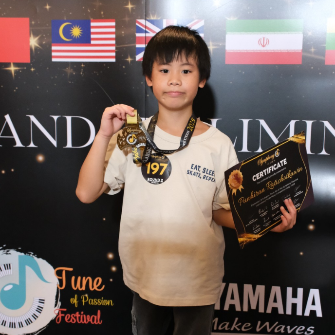 Aizen Year 4 winning 1st Runner-Up Gold Medal in the Drum Set category at the Symphony Classical International Youth Music Competition